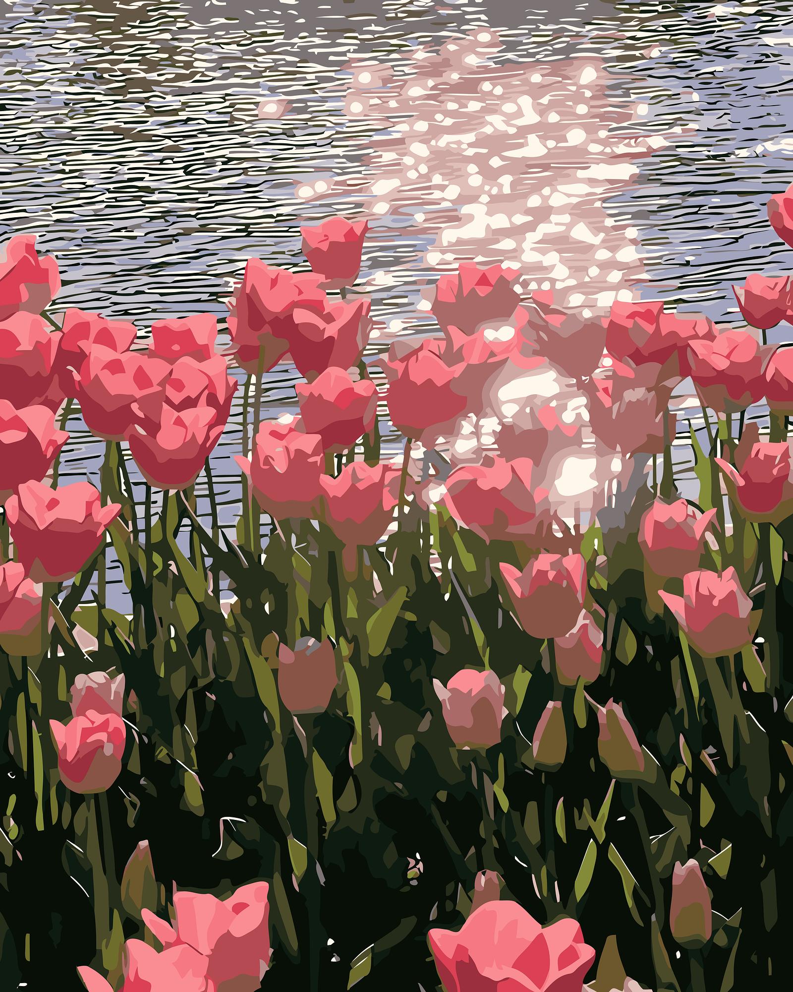 Pink tulips by a body of water with sunlight reflecting on the water surface.