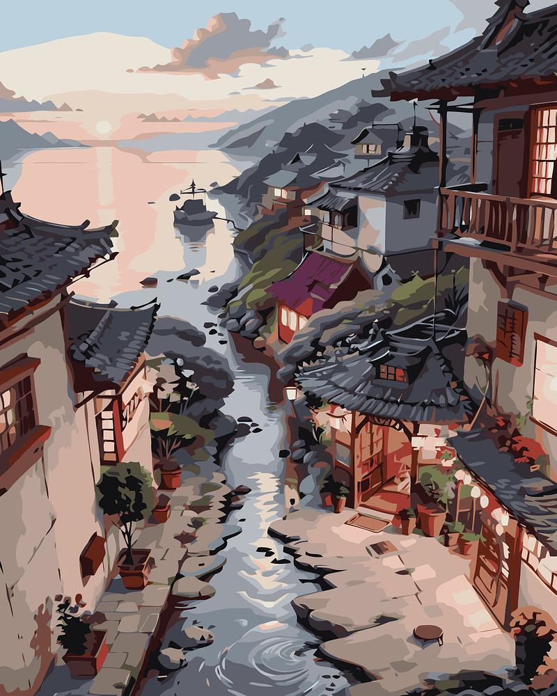 Traditional Japanese village with houses along a river at sunset.