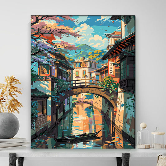Framed artwork of a colorful Japanese-style canal scene with a bridge and traditional buildings.