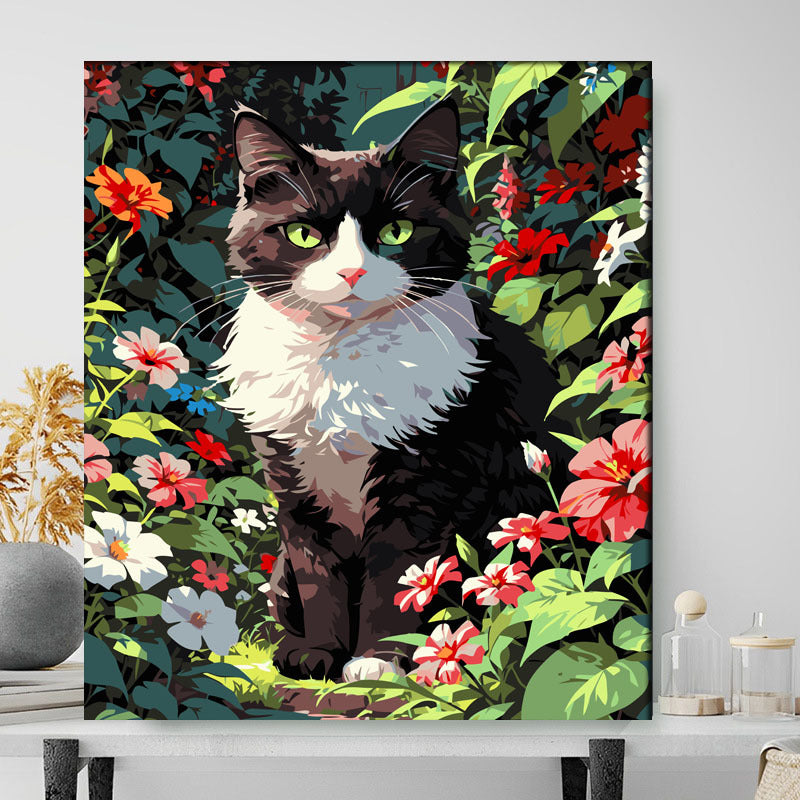 Framed artwork of a black and white cat in a floral garden setting