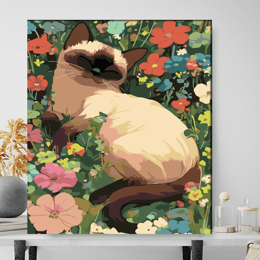 Framed artwork of a Siamese cat among flowers on a wall.
