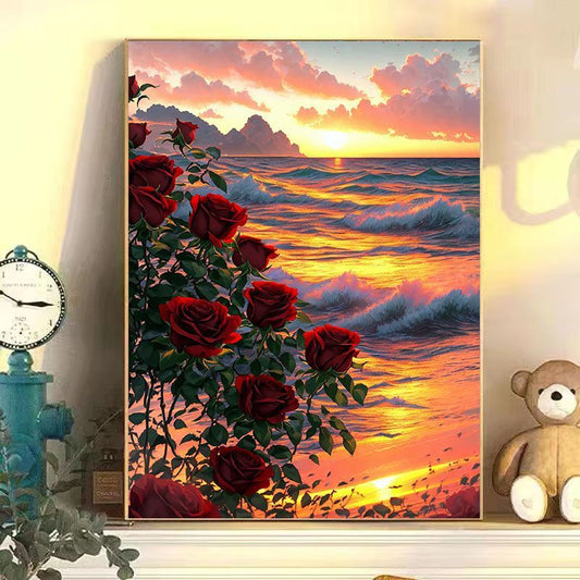 Canvas print of a sunset with red roses over water, placed on a shelf with decorative items.