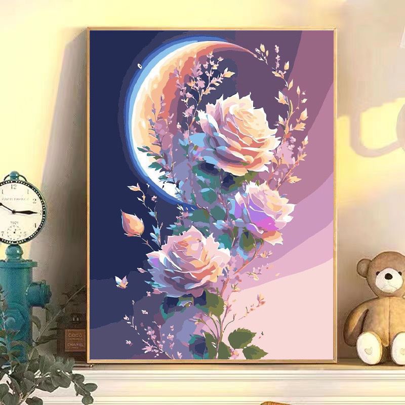 Framed artwork of flowers and a moon on a wall with decorative items.