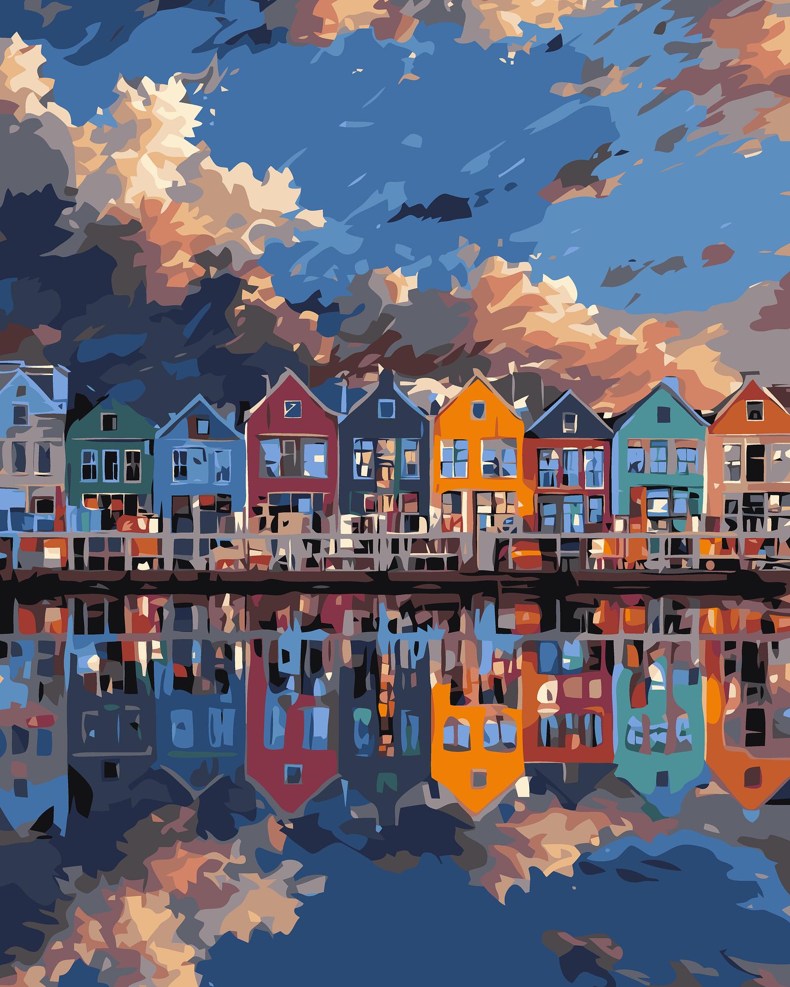 Colorful houses reflected in water with a blue sky.
