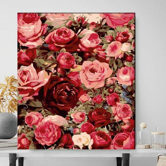 Floral painting with red and pink roses on a white wall