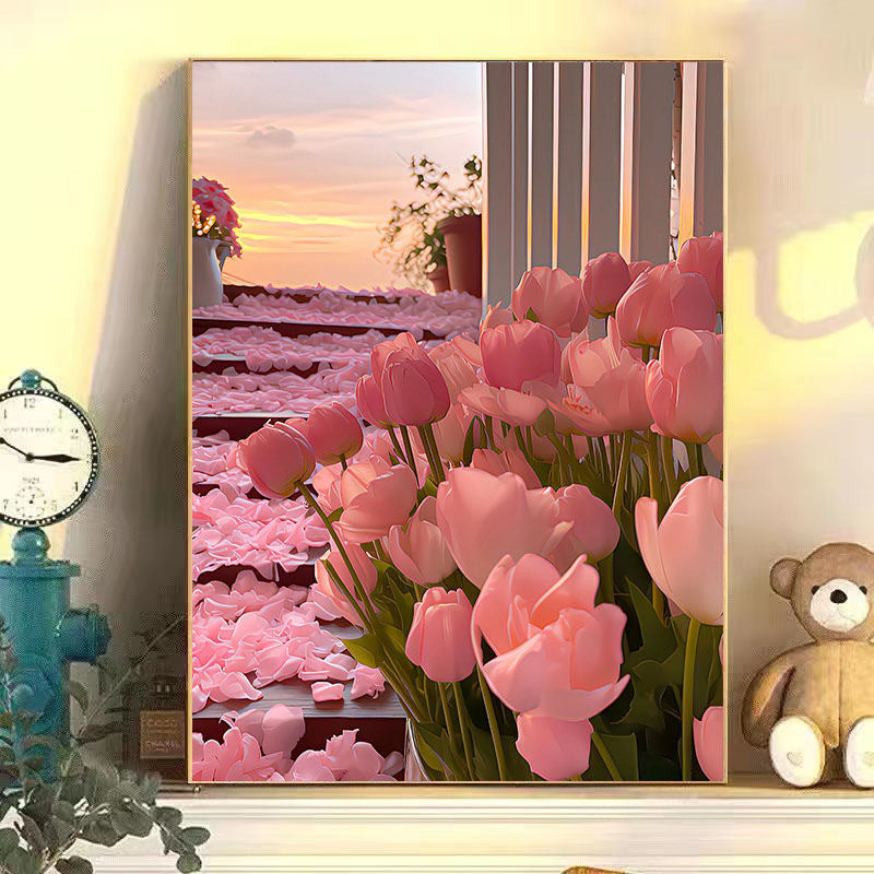 Framed artwork of pink tulips with a sunset scene in the background, displayed on a wall with decor items.