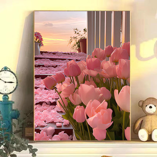 Framed artwork of pink tulips with a sunset scene in the background, displayed on a wall with decor items.